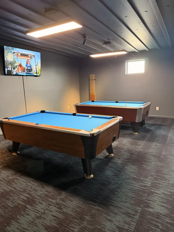 Two pool tables in the game lounge.