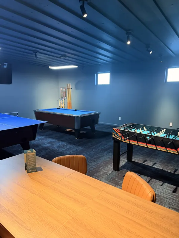 The game lounge with ping pong, pool and foosball tables.